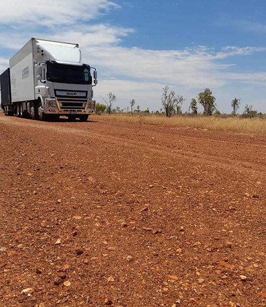 Moving Truck Driving On Dirt Road — Removalists in Bathurst, NSW